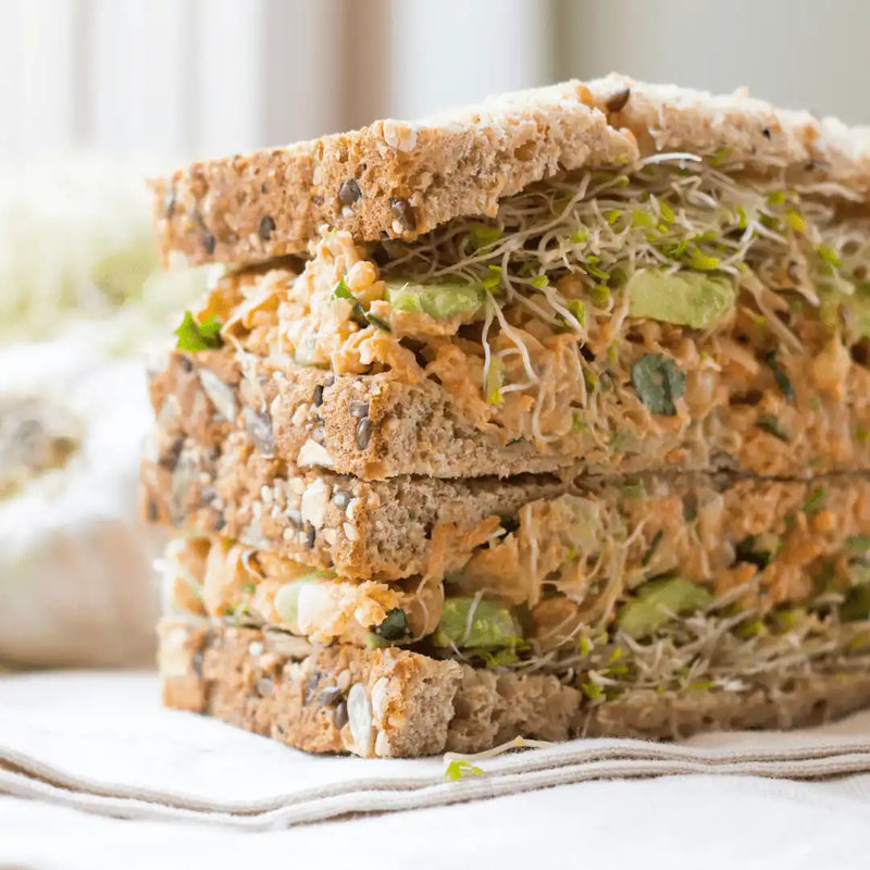alfalfa sprouts layered in a multi-grain seeded bread sandwich