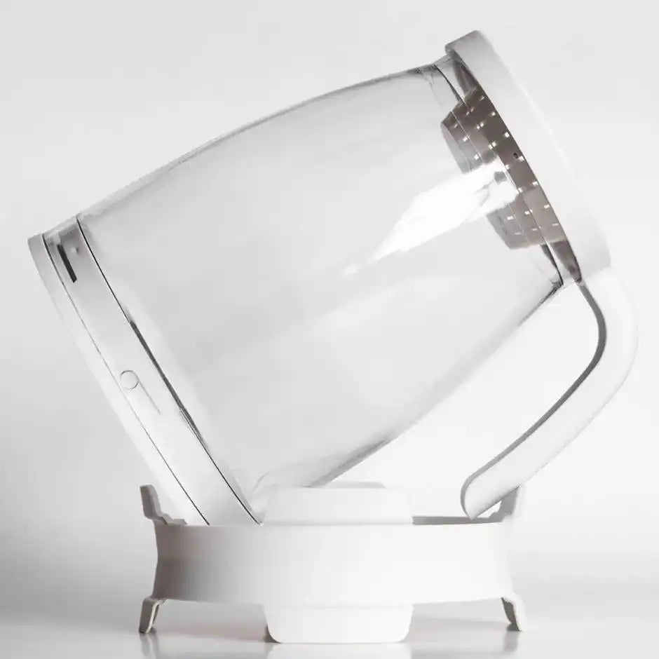 Sprout Spout glass sprouting jar sitting at an angle on its drainage base
