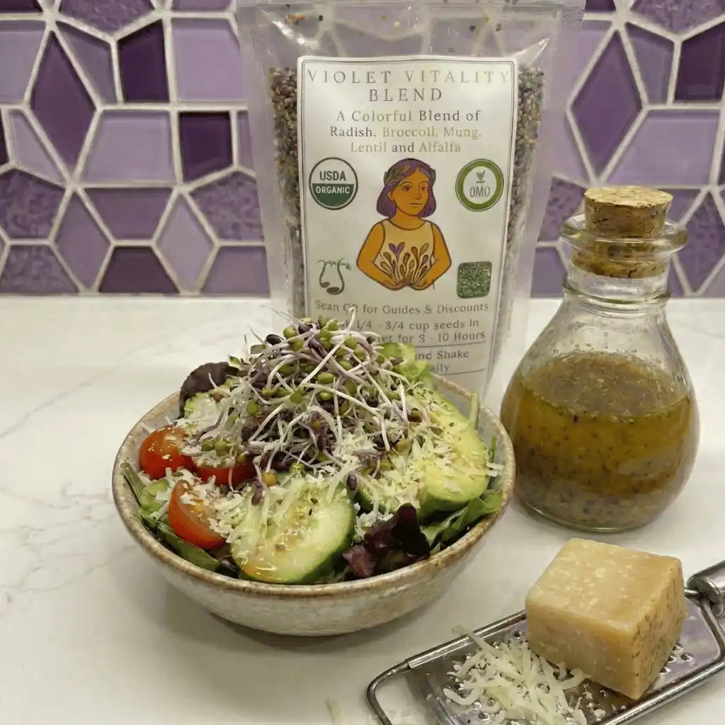 Salad with a bottle of dressing, a block of cheese, and a package labeled 'Violet Vitality Blend' on a tiled wall background.